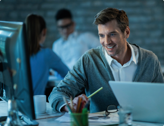 Smiling user at an office workstation