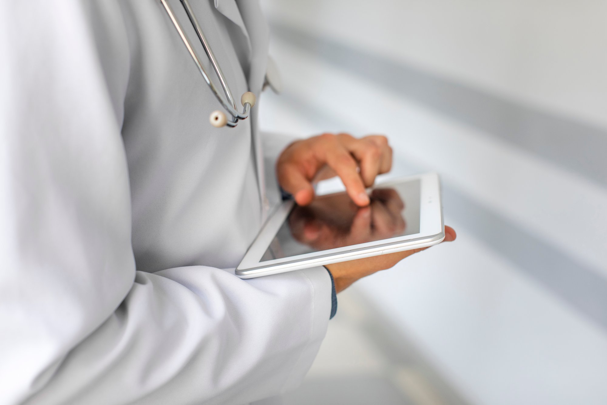 doctor-hands-using-modern-tablet