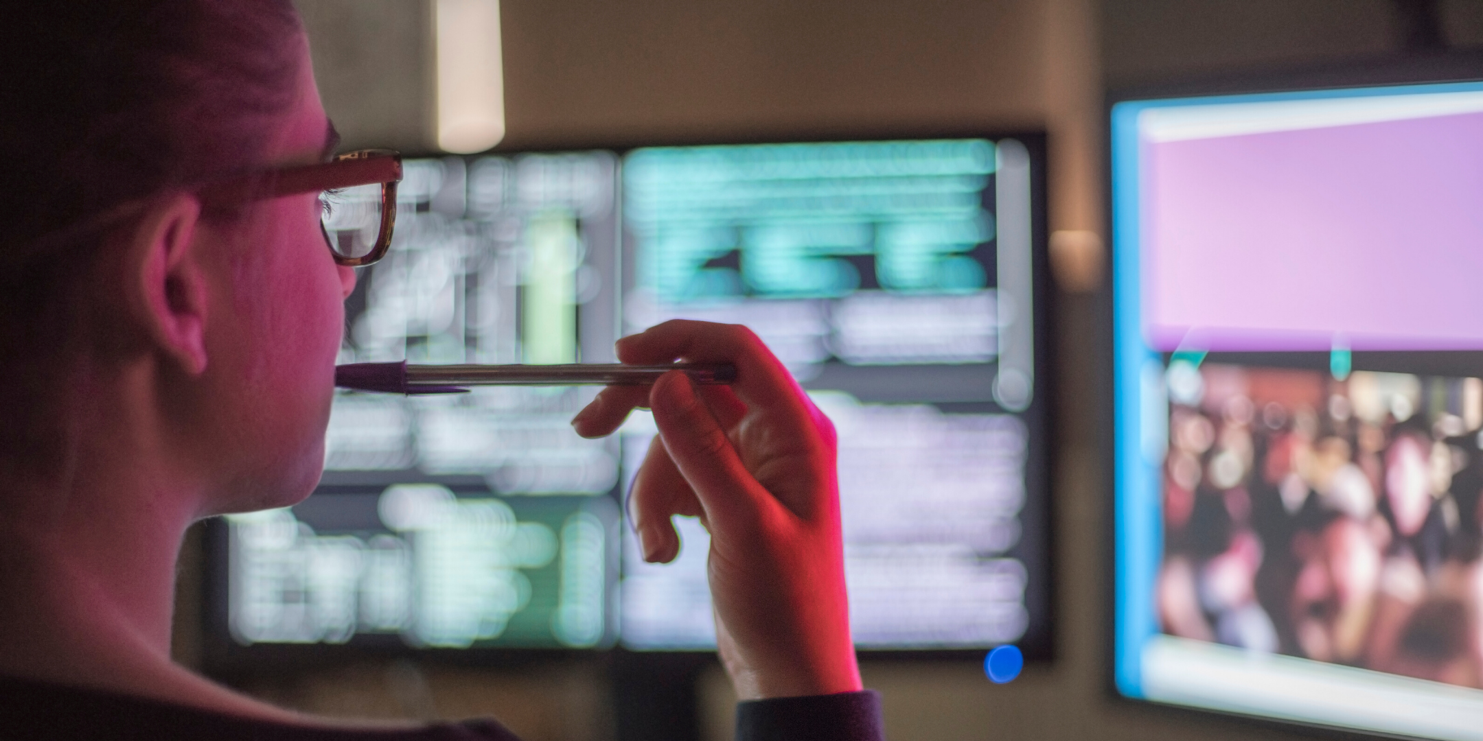 Person looking at computer code on screen in an inquisitive way.